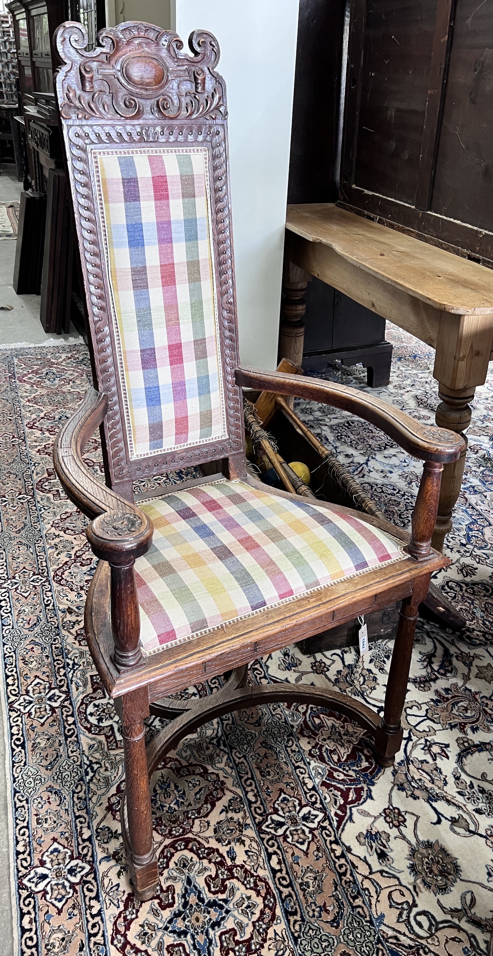 A set of four early 20th century French carved oak elbow chairs, width 59cm, depth 43cm, height 124cm